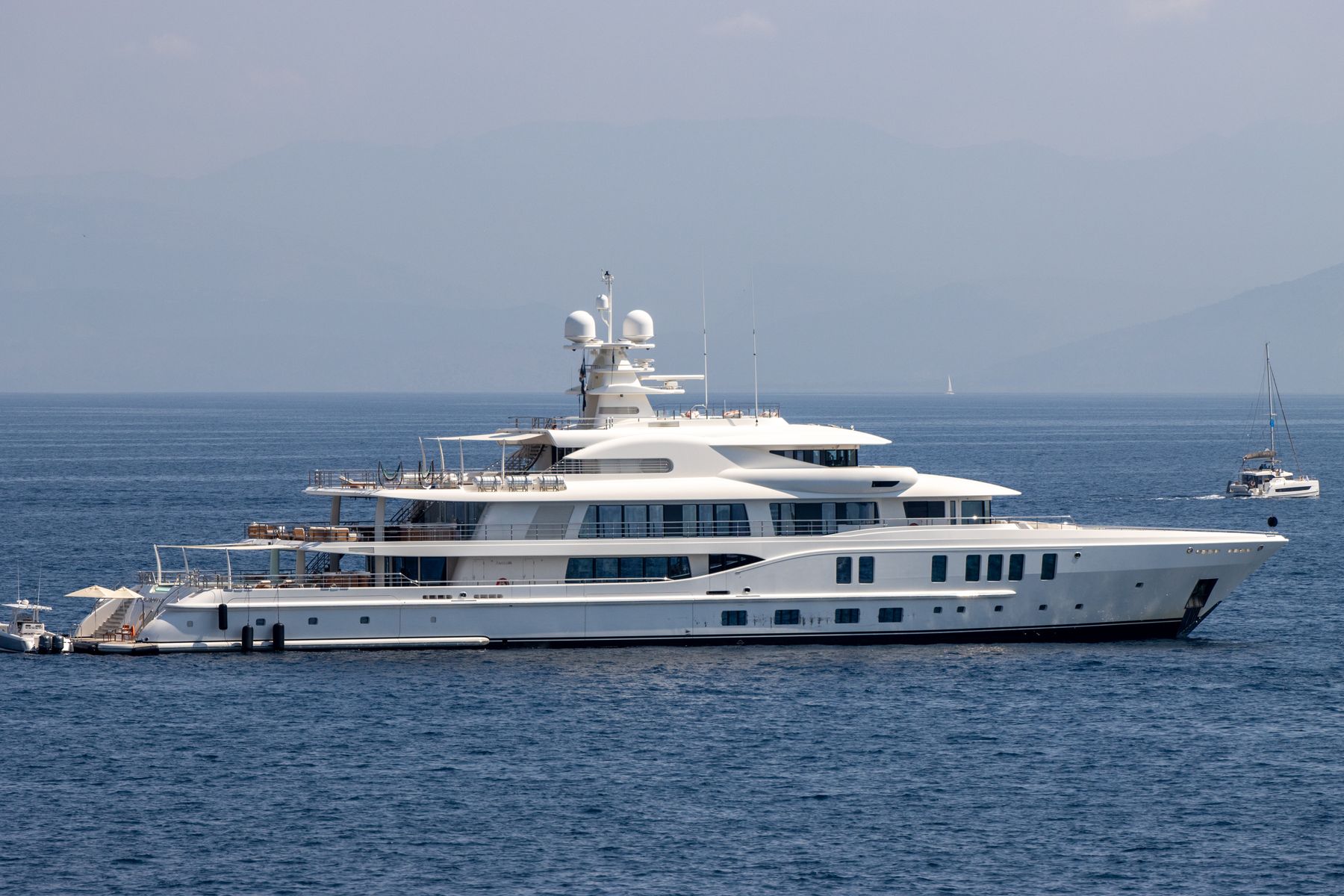 A white motor yacht on a calm blue sea